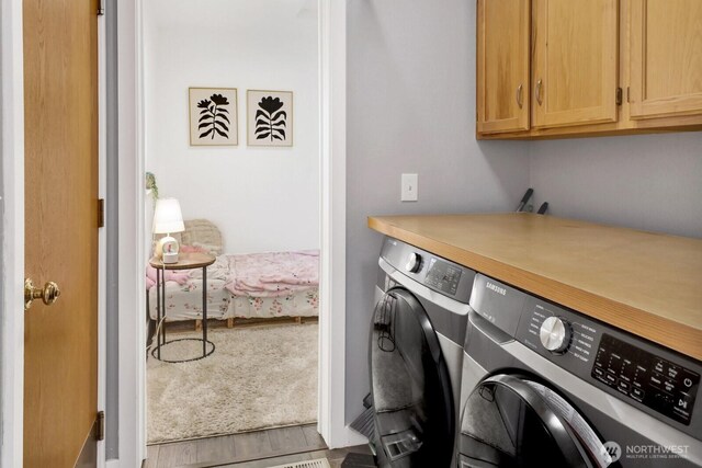 8419 Double Ditch Rd, Lynden, WA 98264 - washroom featuring cabinet space, washing machine and clothes dryer, and wood finished floors