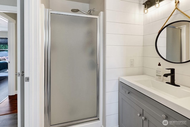 8419 Double Ditch Rd, Lynden, WA 98264 - ensuite bathroom with a stall shower, vanity, and wood finished floors