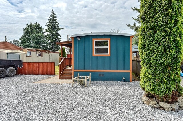 1942 Trigg Rd Unit 38, Ferndale, WA 98248 - view of front of house with board and batten siding, crawl space, and a wooden deck