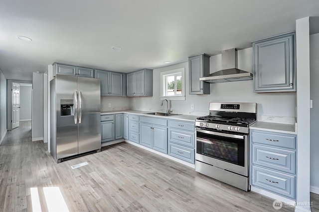 1942 Trigg Rd Unit 38, Ferndale, WA 98248 - kitchen featuring appliances with stainless steel finishes, wall chimney exhaust hood, light countertops, light wood-style floors, and recessed lighting