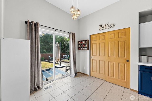 209 Groff Ave NW, Orting, WA 98360 - entrance foyer featuring light tile patterned floors, a chandelier, and a high ceiling