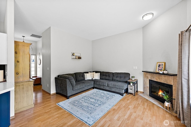 209 Groff Ave NW, Orting, WA 98360 - living room featuring light wood finished floors and a fireplace