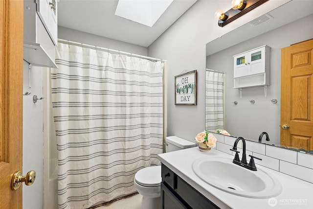 209 Groff Ave NW, Orting, WA 98360 - bathroom featuring vanity, a skylight, and curtained shower