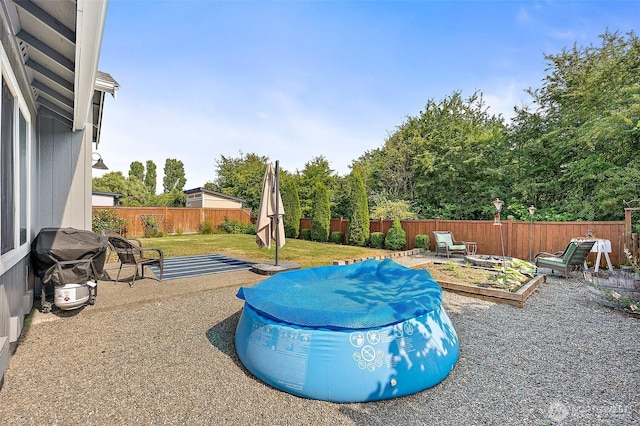 209 Groff Ave NW, Orting, WA 98360 - fenced backyard featuring a vegetable garden