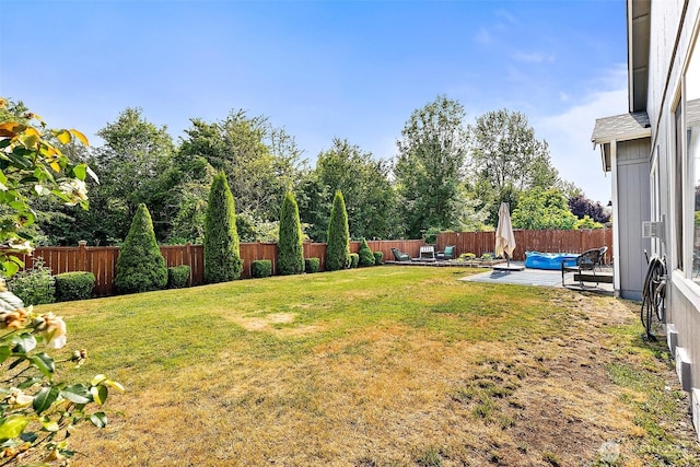 209 Groff Ave NW, Orting, WA 98360 - fenced backyard with a patio and outdoor lounge area