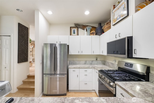 4714 Fairwood Blvd NE Unit 201, Tacoma, WA 98422 - kitchen featuring appliances with stainless steel finishes, light wood-style flooring, light stone countertops, white cabinets, and recessed lighting