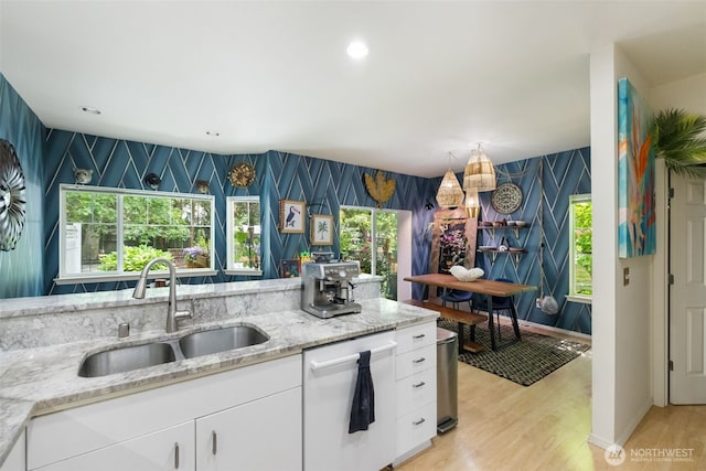 4714 Fairwood Blvd NE Unit 201, Tacoma, WA 98422 - kitchen featuring dishwasher, wallpapered walls, light wood-style flooring, white cabinets, and light stone counters