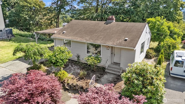 336 25th Ave E, Seattle, WA 98112 - view of front of property featuring a chimney, roof with shingles, view of wooded area, and a front lawn