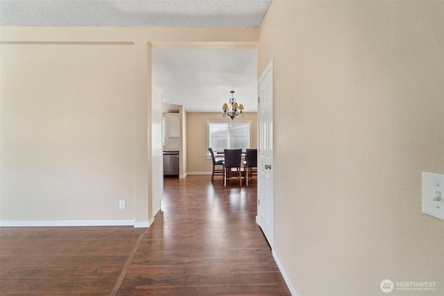 1303 Craig St W, Moses Lake, WA 98837 - hallway with a chandelier and dark wood-style floors