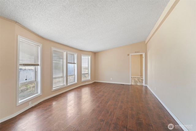 1303 Craig St W, Moses Lake, WA 98837 - empty room with a textured ceiling, wood finished floors, and healthy amount of natural light