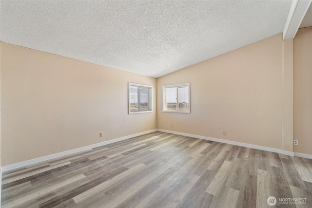 1303 Craig St W, Moses Lake, WA 98837 - unfurnished room featuring a textured ceiling, vaulted ceiling, and light wood-type flooring