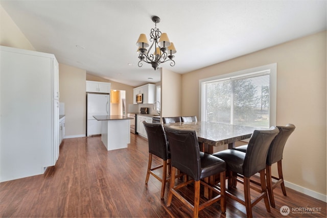 1303 Craig St W, Moses Lake, WA 98837 - dining space featuring a chandelier, dark wood-type flooring, and vaulted ceiling