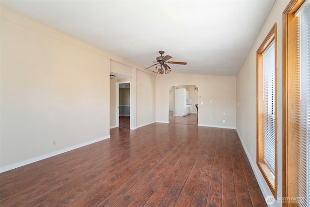 1303 Craig St W, Moses Lake, WA 98837 - unfurnished room featuring arched walkways, ceiling fan, and dark wood-type flooring