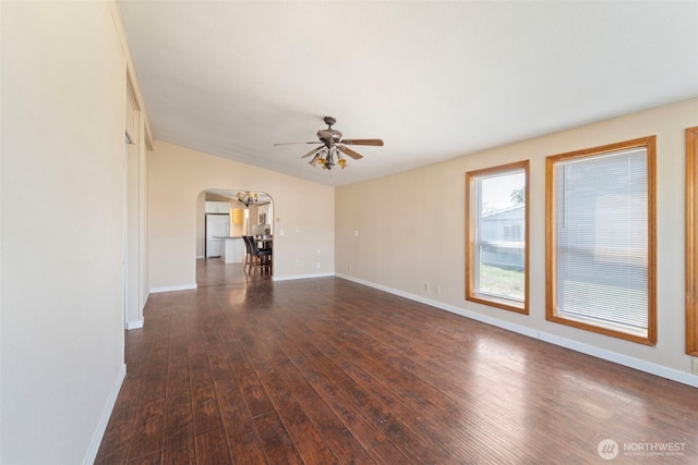 1303 Craig St W, Moses Lake, WA 98837 - unfurnished living room with arched walkways, a ceiling fan, and wood finished floors