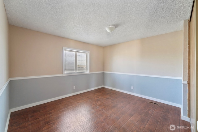 1303 Craig St W, Moses Lake, WA 98837 - unfurnished room with dark wood-type flooring and a textured ceiling