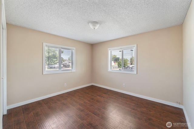 1303 Craig St W, Moses Lake, WA 98837 - spare room with dark wood-type flooring and a textured ceiling