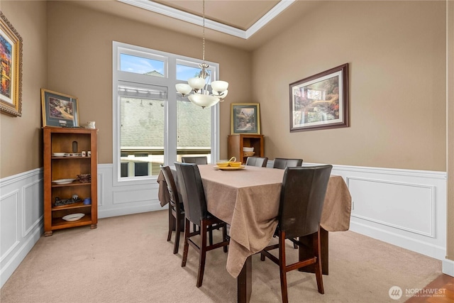 8003 113th Street Ct E, Puyallup, WA 98373 - dining room featuring a chandelier, light carpet, a decorative wall, a wainscoted wall, and ornamental molding