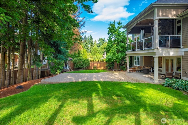 8003 113th Street Ct E, Puyallup, WA 98373 - fenced backyard with a patio area, french doors, and a balcony