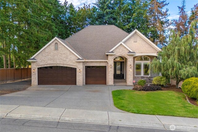 8003 113th Street Ct E, Puyallup, WA 98373 - craftsman-style house with an attached garage, brick siding, and driveway