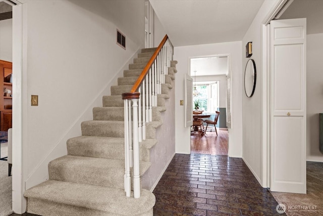 1175 SW Lopez Dr, Oak Harbor, WA 98277 - staircase with brick flooring and baseboards