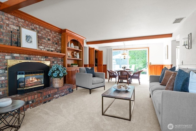 1175 SW Lopez Dr, Oak Harbor, WA 98277 - living area featuring light carpet, a brick fireplace, wainscoting, and beam ceiling