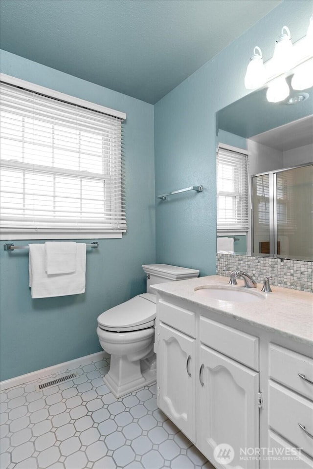 1175 SW Lopez Dr, Oak Harbor, WA 98277 - bathroom with vanity, a shower stall, backsplash, and tile patterned floors