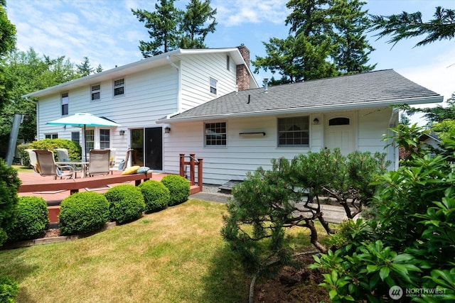 1175 SW Lopez Dr, Oak Harbor, WA 98277 - rear view of house featuring a wooden deck, a lawn, and a chimney