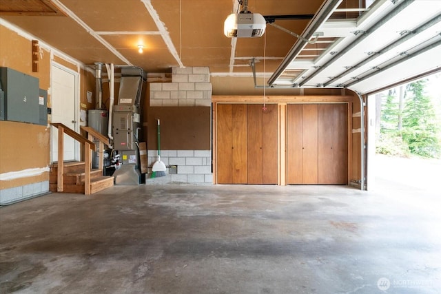 1175 SW Lopez Dr, Oak Harbor, WA 98277 - garage featuring a garage door opener, gas water heater, and heating unit