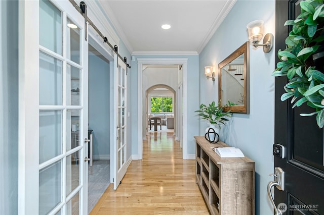 2848 278th Ave SE, Sammamish, WA 98075 - corridor featuring french doors, a barn door, light wood-style flooring, ornamental molding, and recessed lighting