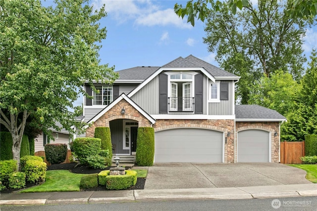 2848 278th Ave SE, Sammamish, WA 98075 - view of front of property featuring stone siding, a balcony, concrete driveway, and a shingled roof