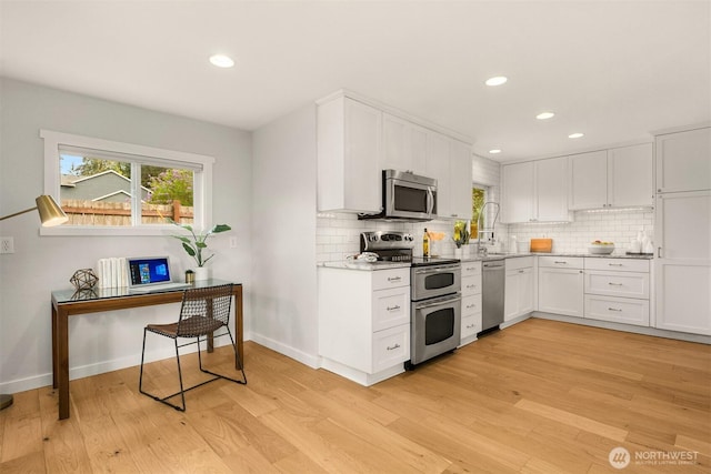 2441 NE 182nd St, Shoreline, WA 98155 - kitchen with stainless steel appliances, light wood-style flooring, plenty of natural light, backsplash, and recessed lighting