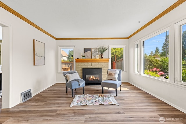 2718 N Alder St, Tacoma, WA 98407 - living area with a brick fireplace, light wood finished floors, and ornamental molding