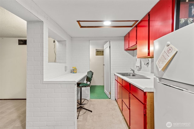2718 N Alder St, Tacoma, WA 98407 - kitchen featuring freestanding refrigerator, red cabinetry, light carpet, and light countertops