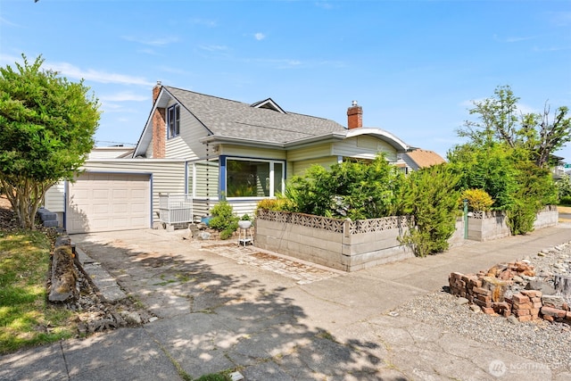2718 N Alder St, Tacoma, WA 98407 - view of front of property with a chimney, a garage, and asphalt driveway