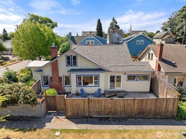 2718 N Alder St, Tacoma, WA 98407 - back of property with a fenced backyard, a patio area, roof with shingles, and a residential view