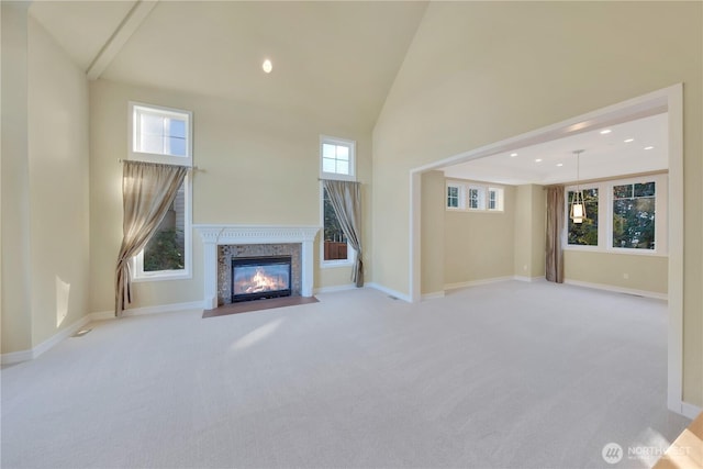 14329 SE 84th Ct, Newcastle, WA 98059 - unfurnished living room with carpet flooring, a fireplace with flush hearth, plenty of natural light, high vaulted ceiling, and recessed lighting
