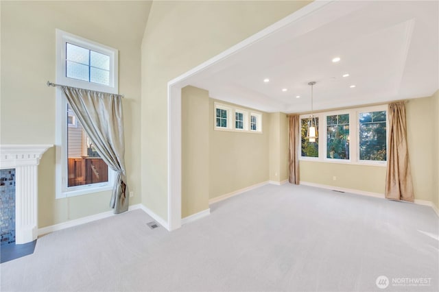 14329 SE 84th Ct, Newcastle, WA 98059 - empty room featuring light carpet, a tray ceiling, a fireplace, and recessed lighting