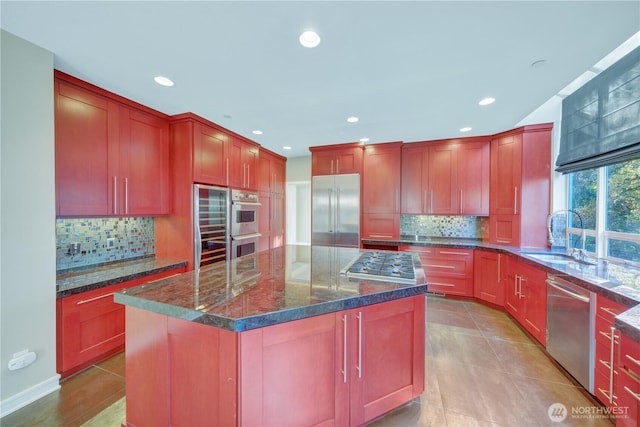 14329 SE 84th Ct, Newcastle, WA 98059 - kitchen with appliances with stainless steel finishes, dark stone countertops, tasteful backsplash, recessed lighting, and a center island
