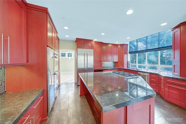 14329 SE 84th Ct, Newcastle, WA 98059 - kitchen with stainless steel appliances, backsplash, a kitchen island, light tile patterned floors, and recessed lighting