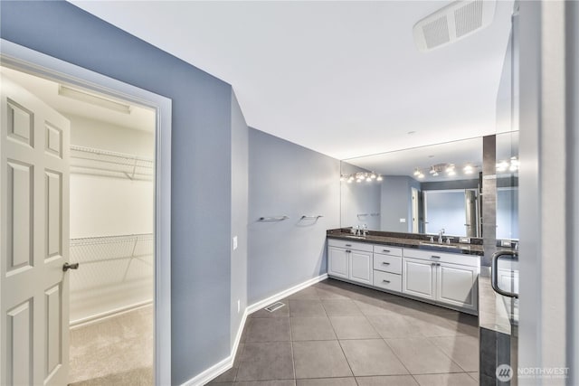 14329 SE 84th Ct, Newcastle, WA 98059 - bathroom featuring double vanity, tile patterned flooring, and a spacious closet