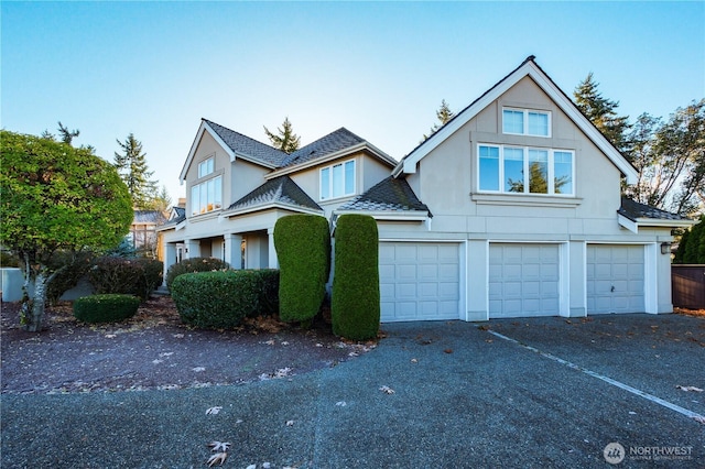 14329 SE 84th Ct, Newcastle, WA 98059 - view of front facade featuring asphalt driveway, stucco siding, an attached garage, and roof with shingles
