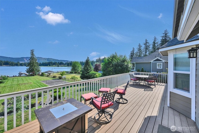 17325 Topaz Loop SE, Yelm, WA 98597 - deck featuring outdoor dining area, a water and mountain view, and a yard