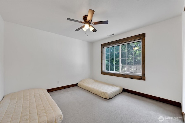 17325 Topaz Loop SE, Yelm, WA 98597 - carpeted bedroom with baseboards and a ceiling fan