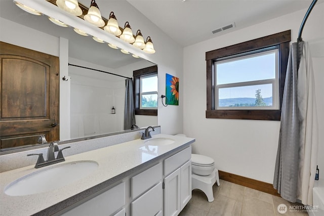 17325 Topaz Loop SE, Yelm, WA 98597 - bathroom with double vanity, tile patterned floors, and shower / tub combo