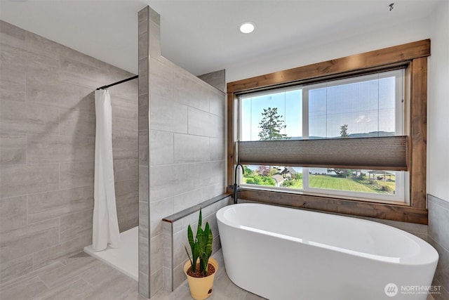 17325 Topaz Loop SE, Yelm, WA 98597 - full bath with a tile shower, a soaking tub, and tile walls