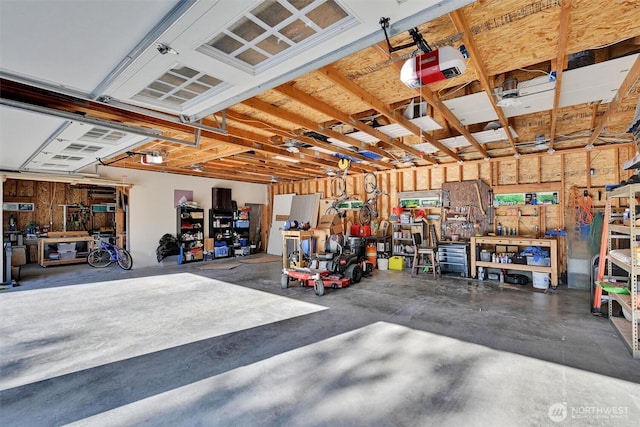 17325 Topaz Loop SE, Yelm, WA 98597 - garage with a workshop area and a garage door opener
