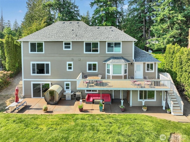 17325 Topaz Loop SE, Yelm, WA 98597 - back of property with a patio, stairs, a wooden deck, and a lawn