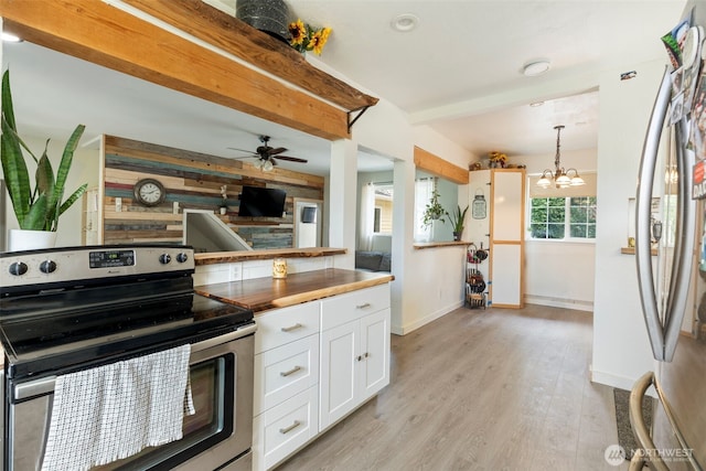 253 Kruger Rd Unit B, Onalaska, WA 98570 - kitchen with stainless steel range with electric stovetop, fridge, white cabinets, light wood-type flooring, and butcher block counters