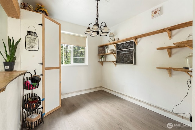 253 Kruger Rd Unit B, Onalaska, WA 98570 - unfurnished dining area featuring wood finished floors and a chandelier