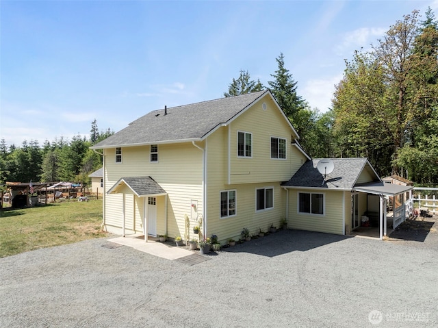 253 Kruger Rd Unit B, Onalaska, WA 98570 - back of house with driveway, a shingled roof, and a yard
